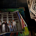 A person flips through 7-inch records